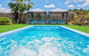 a swimming pool with chairs and a gazebo at Villa Son Gat Mallorca in Montuiri