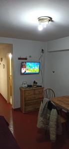 a living room with a television on a wall at San Berardo Brava 3 sobre costanera in San Bernardo