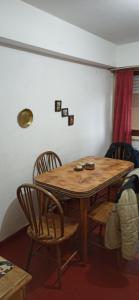 a wooden table and chairs in a room at San Berardo Brava 3 sobre costanera in San Bernardo