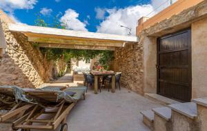 an outdoor patio with a wooden table and chairs at Casa Max in Artá