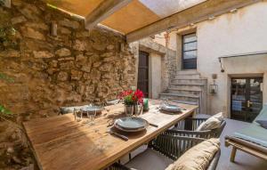 a wooden table in a room with a stone wall at Casa Max in Artá +29 photos