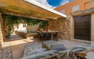 an outdoor patio with a table and a swimming pool at Casa Max in Artá