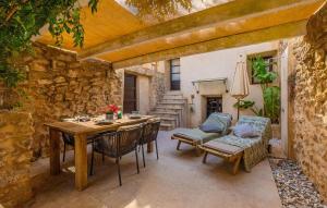 an outdoor patio with a wooden table and chairs at Casa Max in Artá
