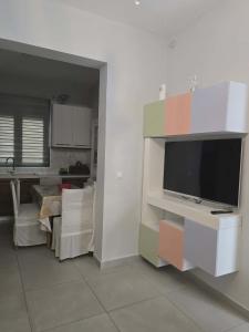 a living room with a flat screen tv on a wall at A&A Apartment in Piraeus