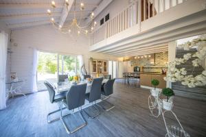 a dining room with a long table and chairs at Zenitude Villa - Indoor Pool & Jacuzzi in Jezainville