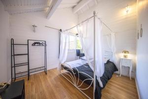 a bedroom with a canopy bed and a window at Zenitude Villa - Indoor Pool & Jacuzzi in Jezainville +53 photos