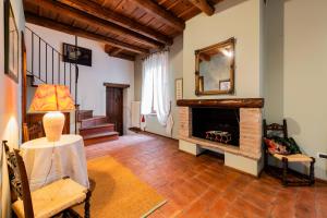 a living room with a fireplace and a staircase at Musella Winery & Relais in San Martino Buon Albergo