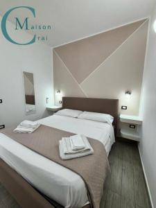 a bedroom with a large bed with towels on it at Residenza Magnolia in Tropea
