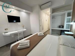 a bedroom with a large bed with towels on it at Residenza Magnolia in Tropea