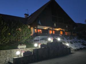 a house with lights in front of it at night at Hotel Panorama in Cavalese