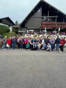 a group of people posing for a picture in front of a building at Hotel Panorama in Cavalese