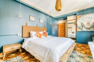 a bedroom with a large bed with blue walls at Martí in La Paz +45 photos