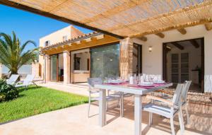a white table and chairs on a patio at Ca Ses Nines in Cala Bona
