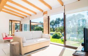 a living room with a white couch and large windows at Ca Ses Nines in Cala Bona +40 photos