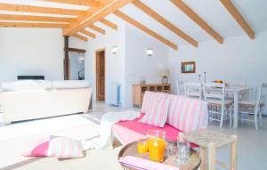 a living room with a pink couch and a table at Ca Ses Nines in Cala Bona