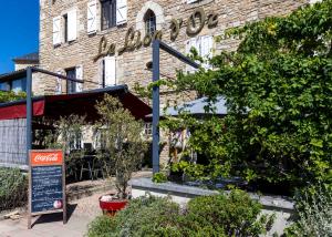 a building with a cocacola sign in front of it at Logis Hôtels - Hôtel et Restaurant Le Lion d'Or in Gramat