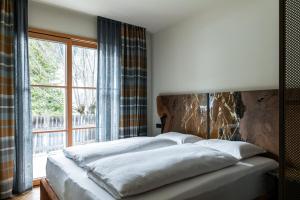 a bedroom with a large bed with a large window at Chalet Corvara in Corvara in Badia