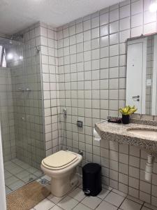 a bathroom with a toilet and a sink and a mirror at Mar doce lar in São Luís
