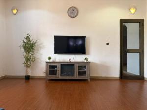 a living room with a flat screen tv on a wall at Résidence huele in Ouagadougou