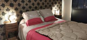 a bed with red and white pillows on it at Carpe Diem in Saint-Savin