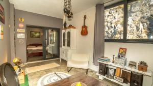 a living room with a guitar on the wall at Lux Apartment Sunset in Virpazar