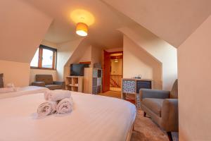 a bedroom with two beds and a living room at Silverwood Stylish House - Pass the Keys in Telford