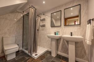 a bathroom with a sink and a shower and a toilet at Silverwood Stylish House - Pass the Keys in Telford +44 photos