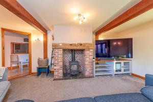a living room with a brick fireplace at Silverwood Stylish House - Pass the Keys in Telford