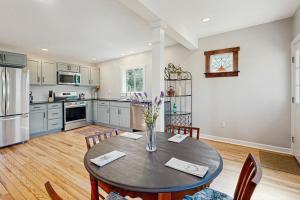 a kitchen with a table and chairs in a kitchen at Private Patio & Pond: Serene Black Mountain Escape in Black Mountain +19 photos