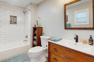 a bathroom with a toilet and a tub and a sink at Private Patio & Pond: Serene Black Mountain Escape in Black Mountain