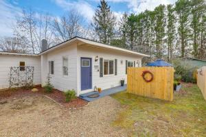 a small white house with a wooden fence at Private Patio & Pond: Serene Black Mountain Escape in Black Mountain
