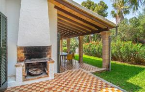 a patio with a brick fireplace in a backyard at El Tulipan Blanco in Alcudia +34 photos