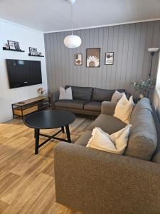a living room with a couch and a table at Leilighet Vingnes in Lillehammer