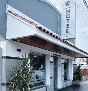 a building with a sign for the hotel at Petit Hotel Las Marias in La Rioja