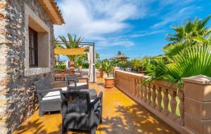 a patio with chairs and tables on a wall at Ca Na Pepa in Muro +44 photos