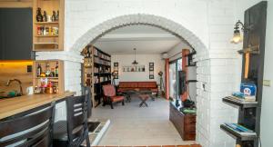 an archway leads into a living room with a piano at Lux Apartment Sunset in Virpazar