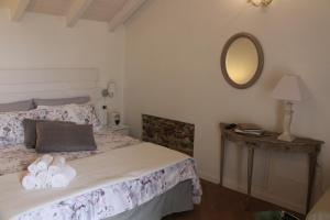 a bedroom with a bed with a mirror on the wall at La Piccola Corte Malpensa, 8 minuti d'auto in Vizzola Ticino