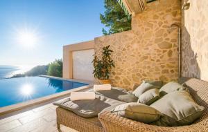 a wicker couch sitting on a patio next to a pool at Ventimar in Canyamel
