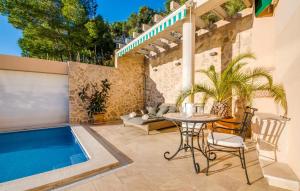 a patio with a table and a swimming pool at Ventimar in Canyamel