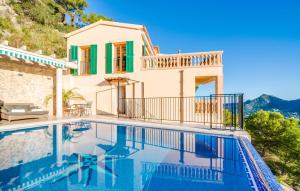 a villa with a swimming pool and a house at Ventimar in Canyamel