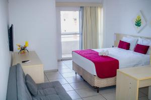 a hotel room with a bed and a couch at TerrazzoPontaNegraDJ in Natal +31 photos