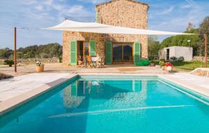 a villa with a swimming pool in front of a house at Son Frare in Artá