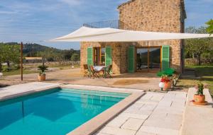 a villa with a swimming pool and a building at Son Frare in Artá