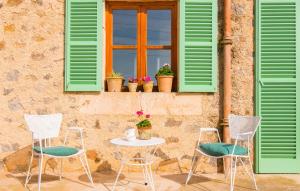 a table and chairs and a window with green shutters at Son Frare in Artá +33 photos