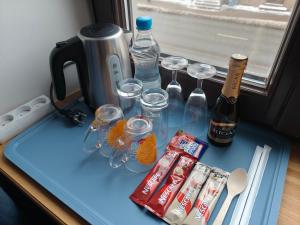 a table with glasses and bottles of alcohol on it at Red Doors Apartament 23 Free Parking in Riga
