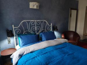 a bedroom with a blue bed with a metal headboard at Red Doors Apartament 23 Free Parking in Riga +1 photo