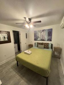 a bedroom with a bed with a ceiling fan at Studio Apartment Antonine in New Orleans