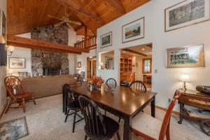 a dining room and living room with a wooden table at Meadow Lake View by Railey Vacations in Swanton +42 photos