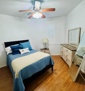 a bedroom with a blue bed and a ceiling fan at Homes by Abby LLC in Maricopa