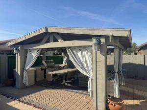 an outdoor pavilion with a table and a desk at Homes by Abby LLC in Maricopa